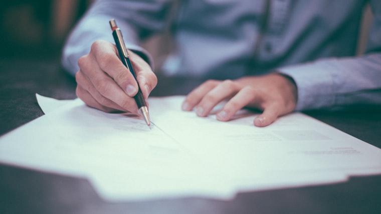 Notebook and documents on a clean desk — resume length decision